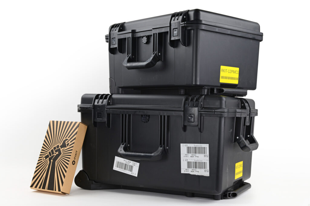 Apple Self Service Repair kit with tools and components on workbench.
